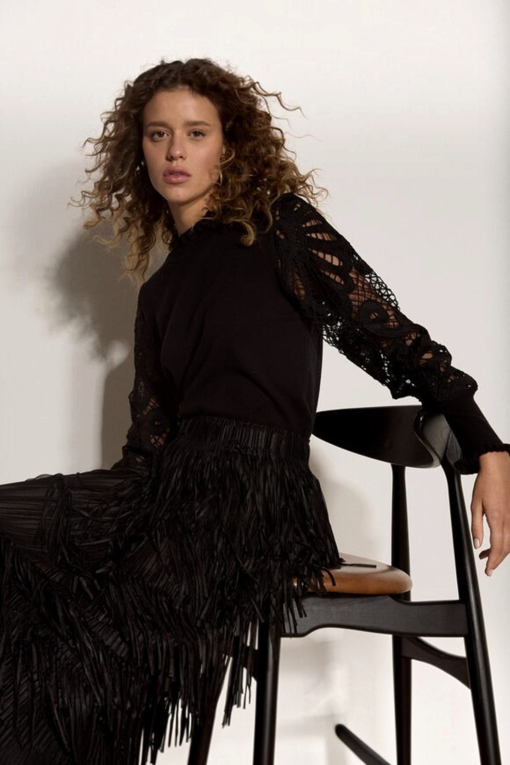 Broderick's Clothing Co. black knit sweater with intricate guipure lace mesh sleeves and lettuce trim crew neck