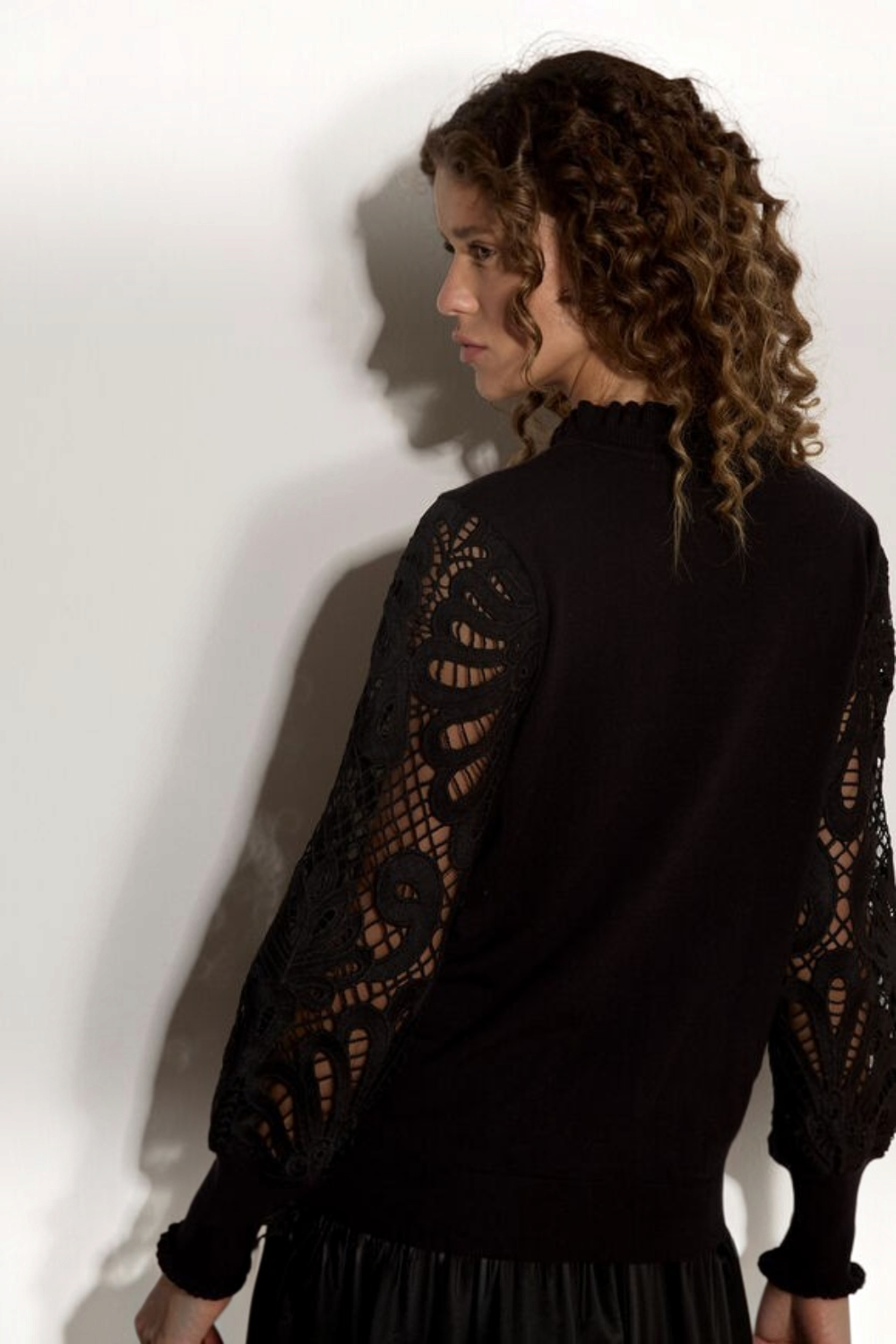 Broderick's Clothing Co. black jumper with intricate guipure lace mesh sleeves and a lettuce trim crew neck