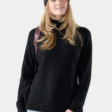 Broderick's Clothing Co. woman wearing a black speckled Merino wool blend tunic sweater and a grey knit beanie.