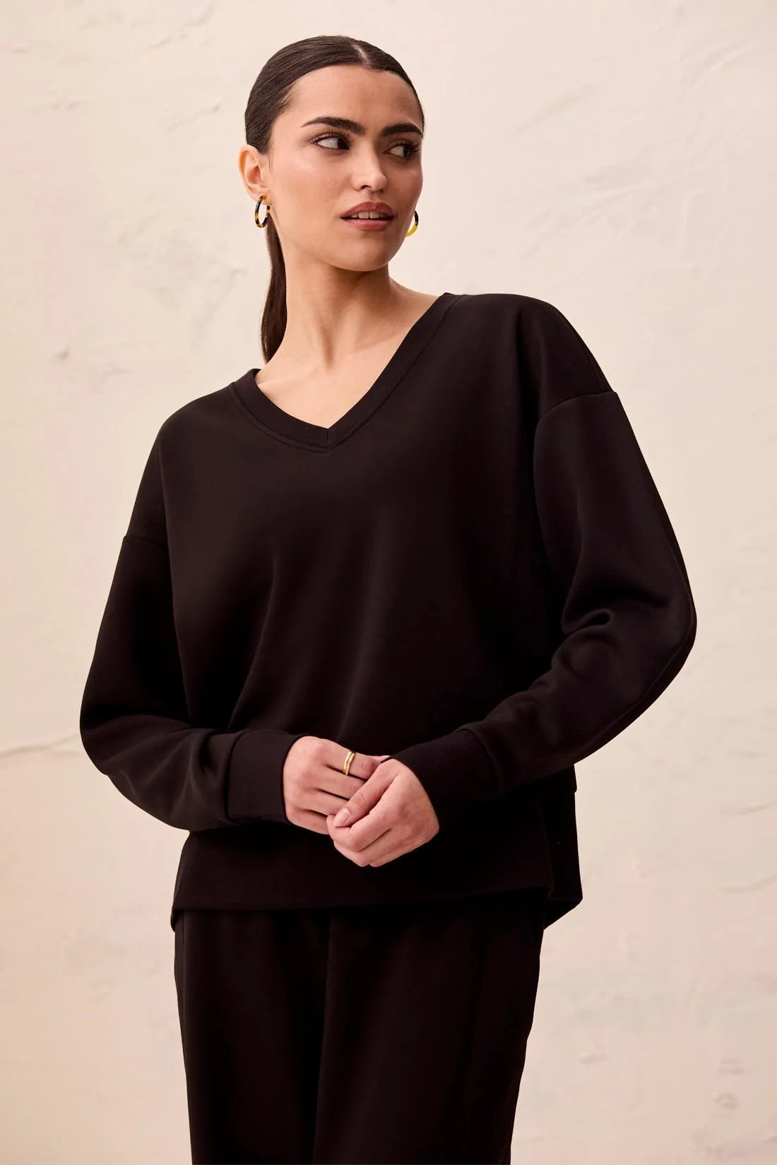 Broderick's Clothing Co. black V-neck pullover in Techno Lux scuba knit with drop shoulders and ribbed hem