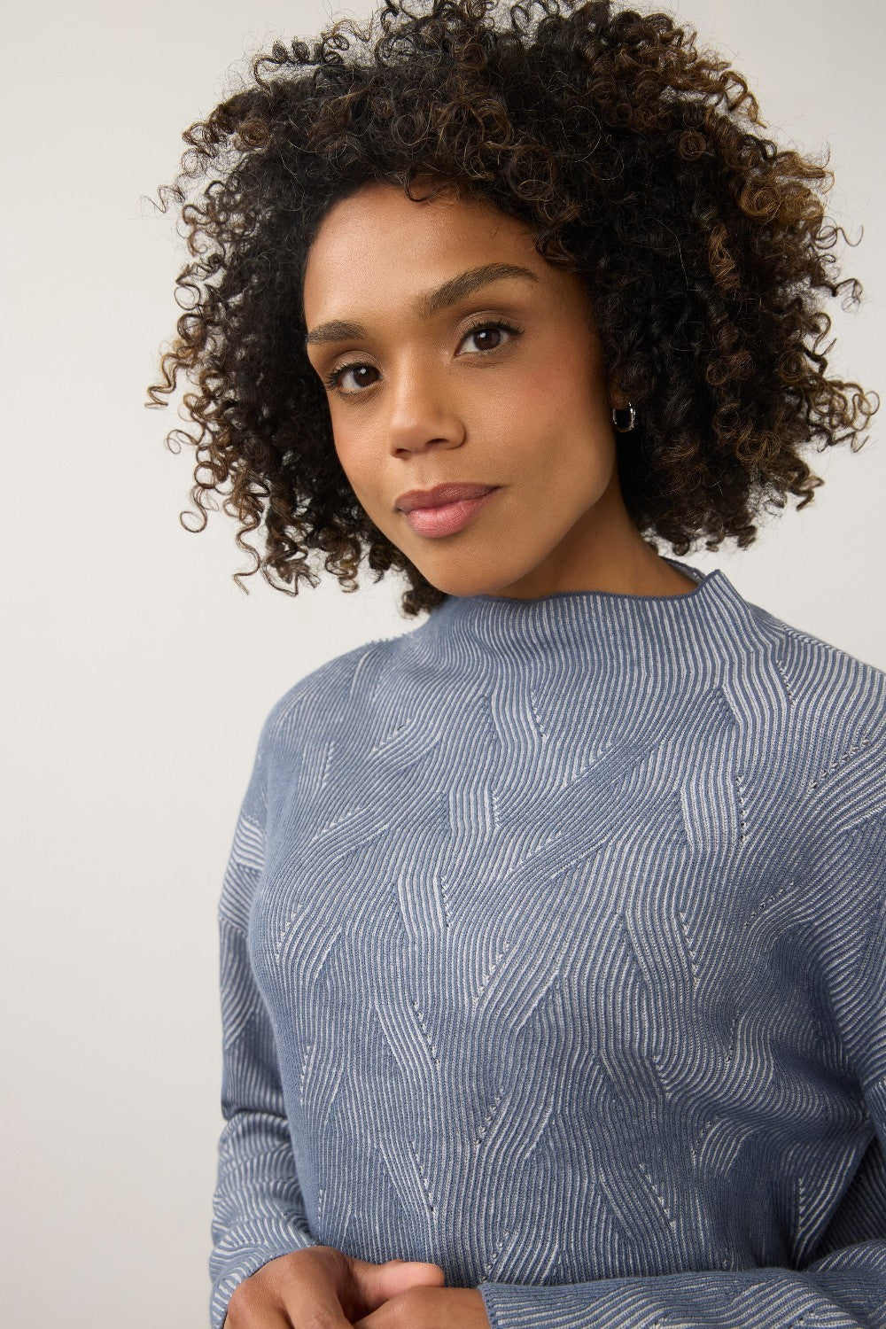 Broderick's Clothing Co. FDJ long sleeve funnel neck sweater in blue with a textured wavy knit pattern on a model