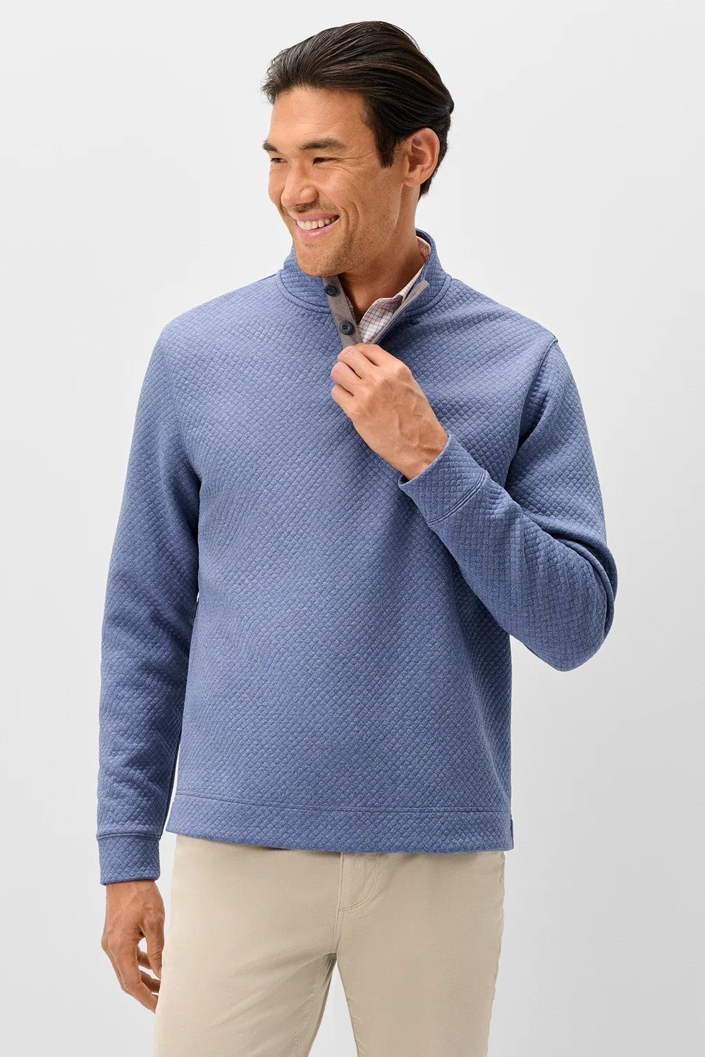Broderick's Clothing Co. blue diamond quilted henley pullover with suede placket details worn by a smiling man
