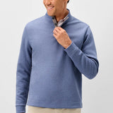 Broderick's Clothing Co. blue diamond quilted henley pullover with suede placket details worn by a smiling man