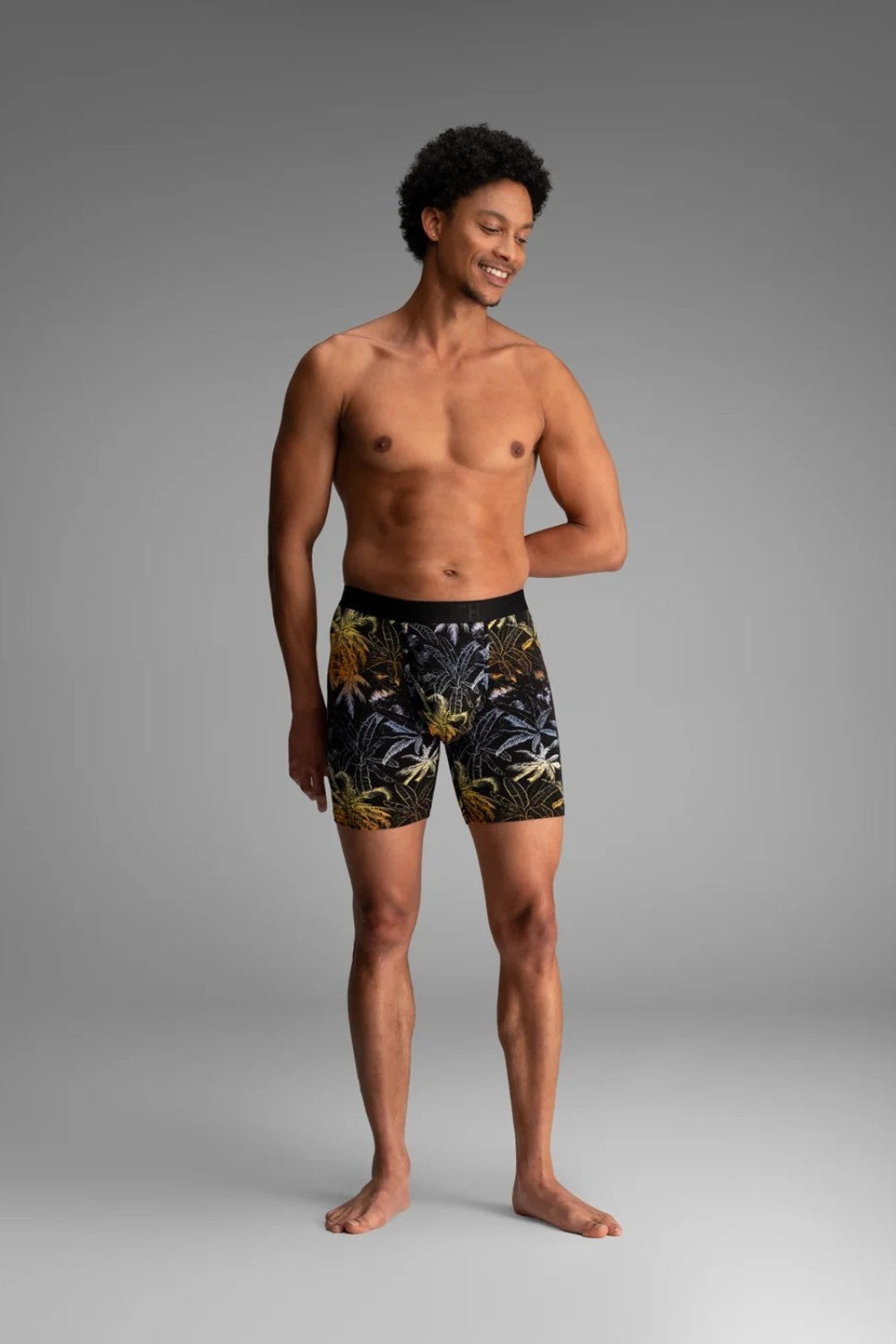 Broderick's Clothing Co. BN3TH Classic Icon boxer brief with a black and gold tropical palm print on a male model.