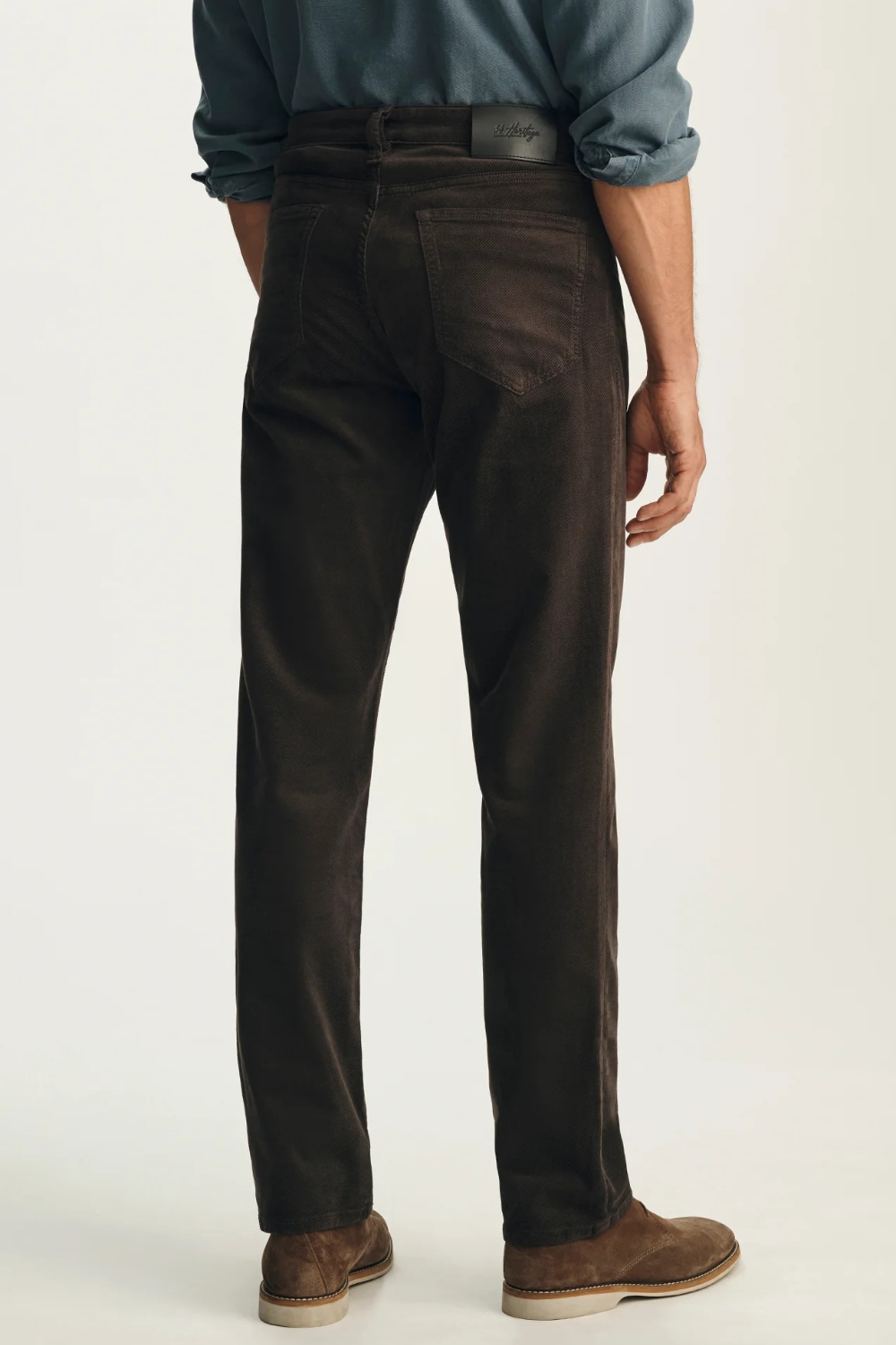 Broderick's Clothing Co. 34 Heritage brown corduroy-style straight leg pants worn by a man from the back view.