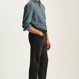 Broderick's Clothing Co. 34 Heritage Charisma brown corduroy-style straight leg pants worn by a man in a blue shirt.