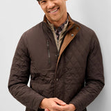 Broderick's Clothing Co. Johnnie-O Juno brown diamond-quilted snap jacket with suede trim worn by a smiling man