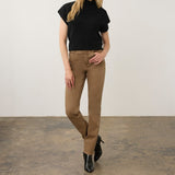 Model wearing Broderick's Clothing Co. FDJ Suzanne high-rise straight leg brown jeans with a black top and boots.