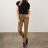 Model wearing Broderick's Clothing Co. FDJ Suzanne high-rise straight leg brown jeans with a black top and boots.