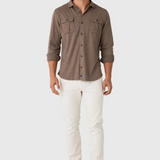 Broderick's Clothing Co. Johnnie-O brown twill overshirt with dual chest pockets worn by a smiling man in white jeans.