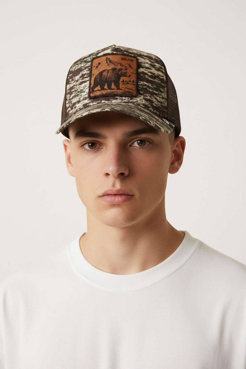 Broderick's Clothing Co. Goorin Bros. camo trucker hat with an engraved bear patch worn by a young man