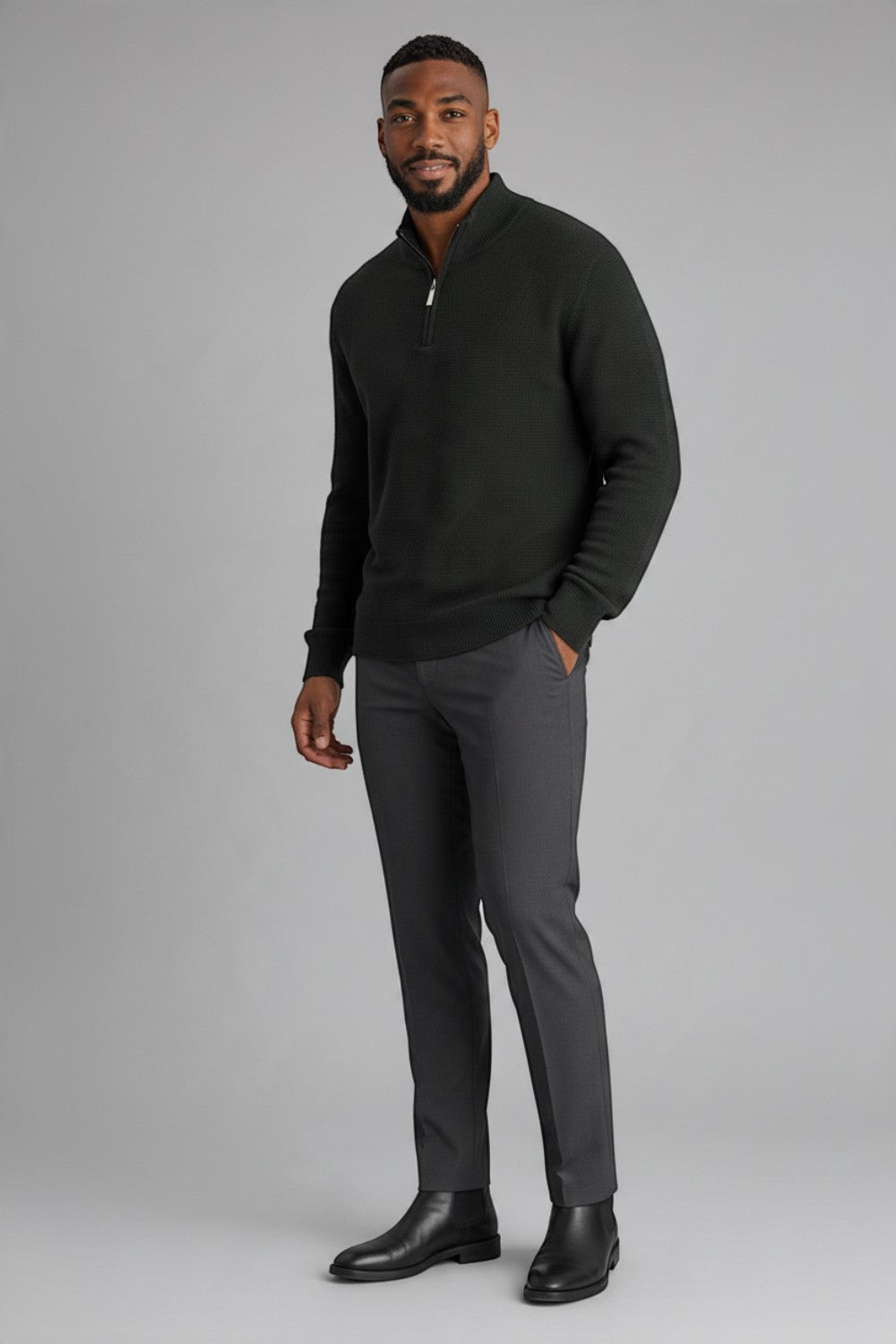 Broderick's Clothing Co. charcoal grey textured cotton quarter-zip sweater worn by a man with grey trousers.