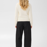 Broderick's Clothing Co. cream long-sleeve knit pullover with ribbed trim worn with black pinstripe trousers
