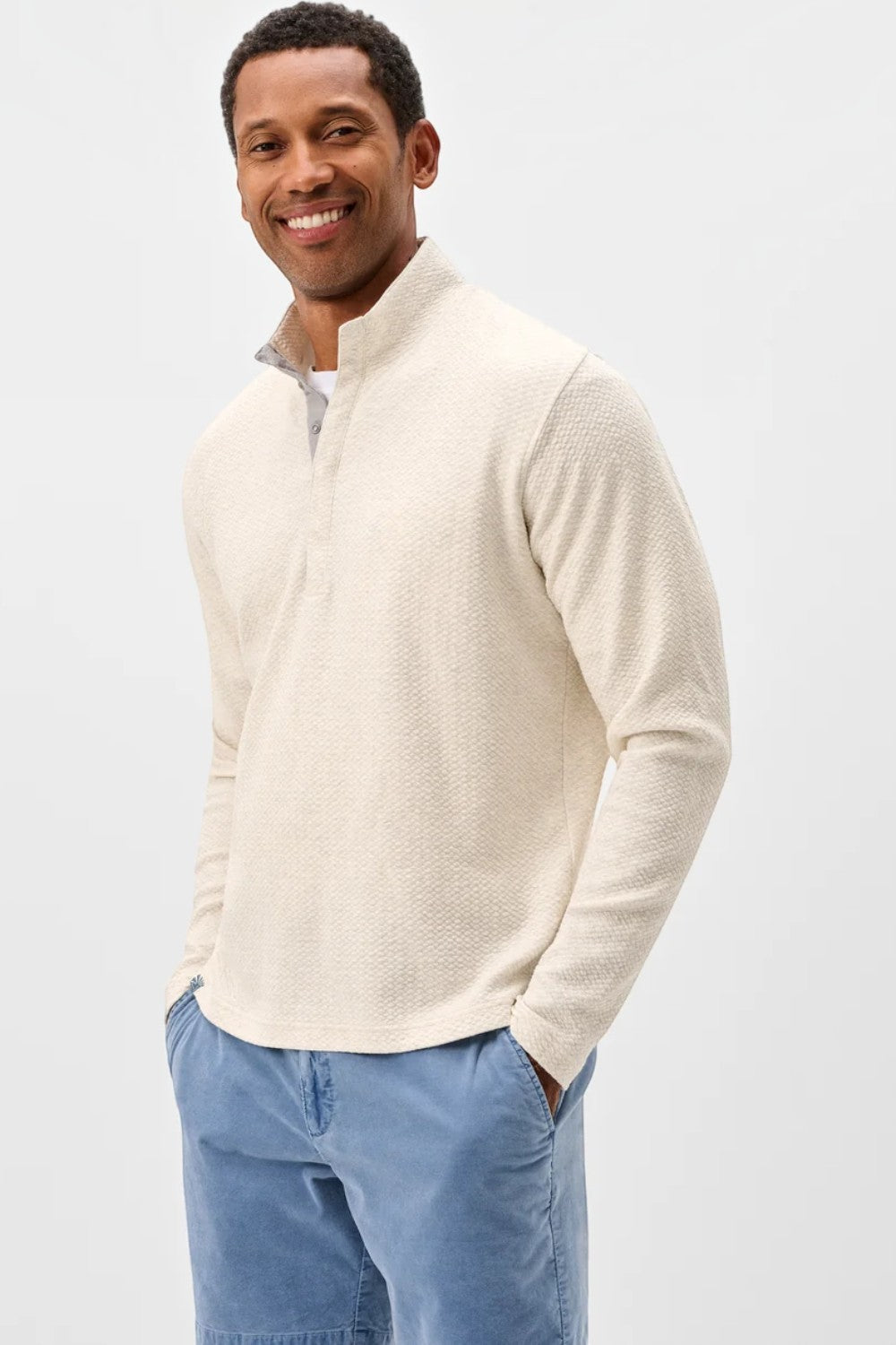 Broderick's Clothing Co. cream textured knit pullover with a hidden snap placket worn by a man.