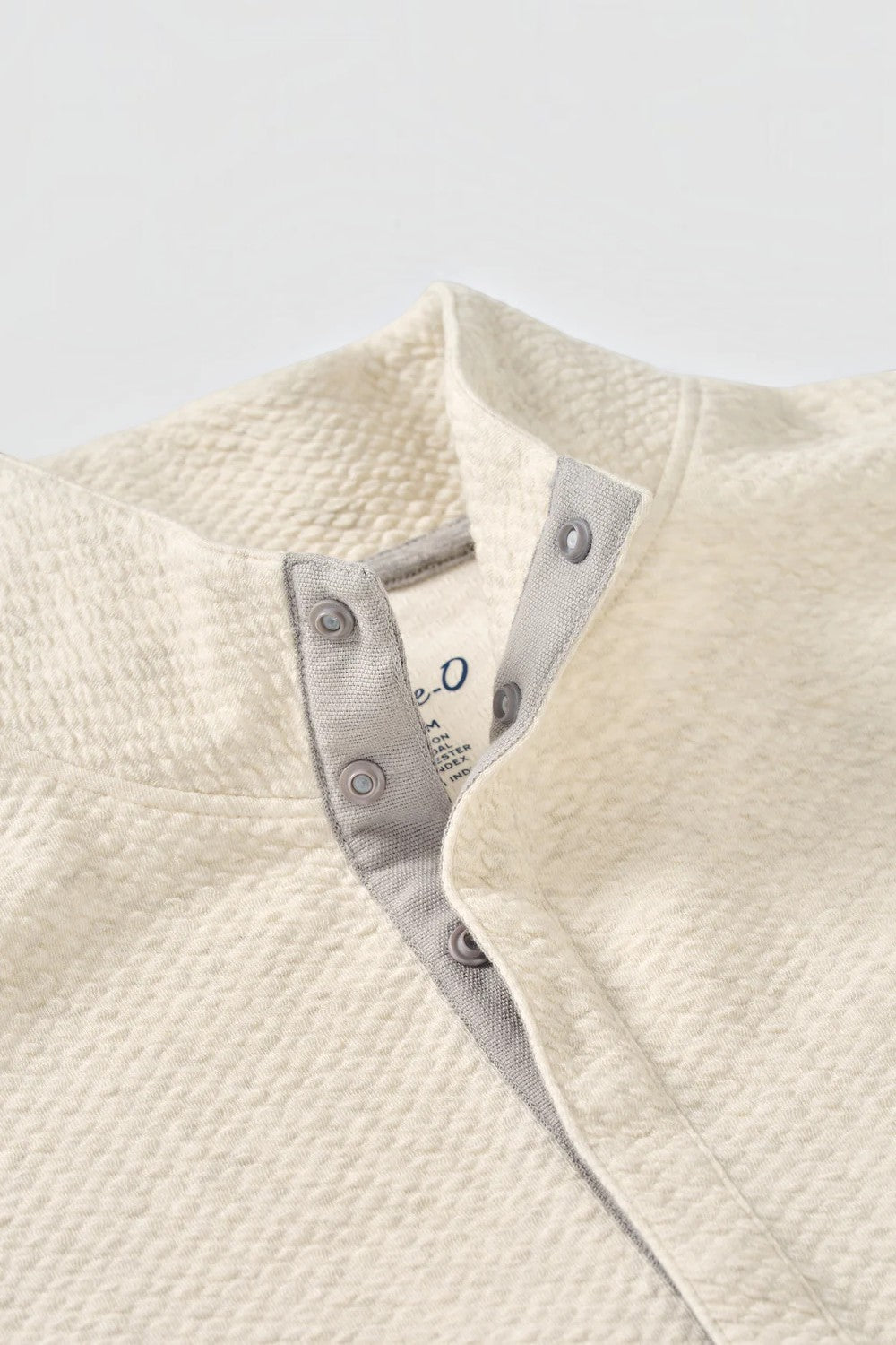 Broderick's Clothing Co. cream textured knit pullover featuring a hidden snap placket and soft cotton-modal blend.