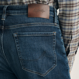 Broderick's Clothing Co. 34 Heritage dark vintage straight leg jeans with brown leather patch and contrast stitching
