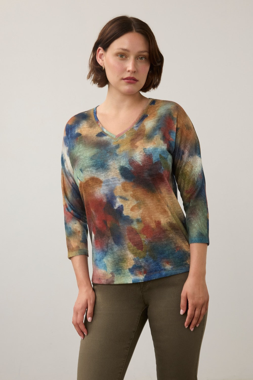 Model wearing a Broderick's Clothing Co. FDJ drop shoulder 3/4 sleeve top with a multi-color abstract fall print.