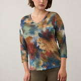 Model wearing a Broderick's Clothing Co. FDJ drop shoulder 3/4 sleeve top with a multi-color abstract fall print.