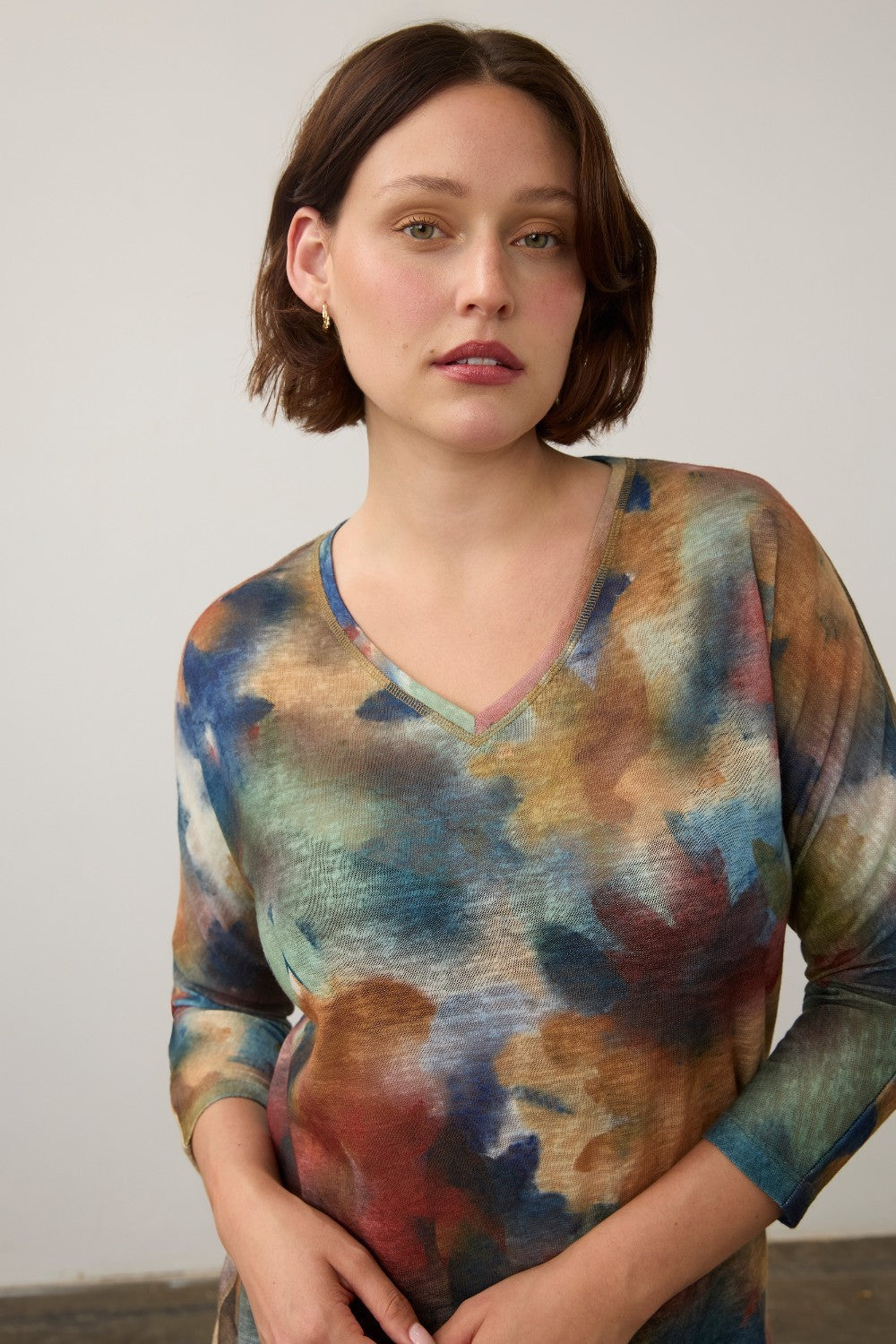 Broderick's Clothing Co. FDJ drop shoulder 3/4 sleeve top in a multi-colored fall-toned abstract print.
