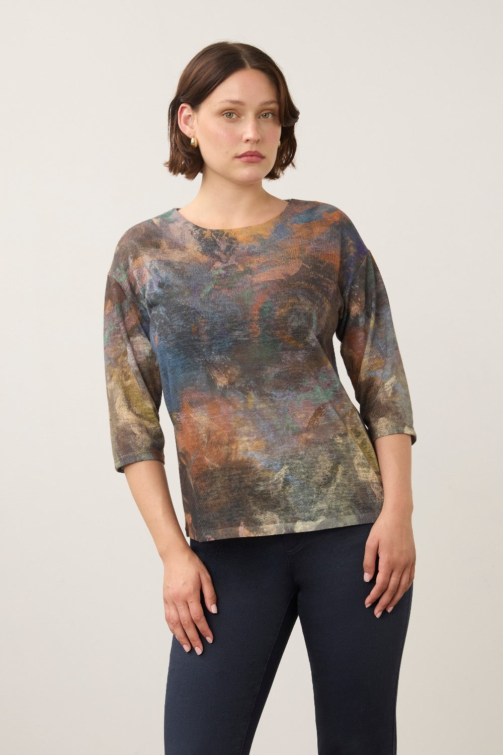 Model wearing a Broderick's Clothing Co. FDJ 3/4 sleeve top with a multi-coloured abstract print and relaxed fit.