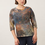 Model wearing a Broderick's Clothing Co. FDJ 3/4 sleeve top with a multi-coloured abstract print and relaxed fit.
