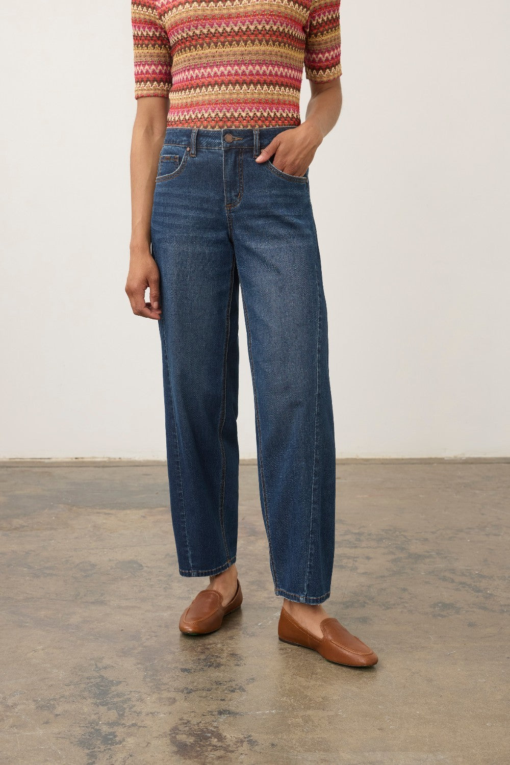 Model wearing Broderick's Clothing Co. FDJ Girlfriend Barrel Ankle denim jeans with a relaxed, tapered fit.