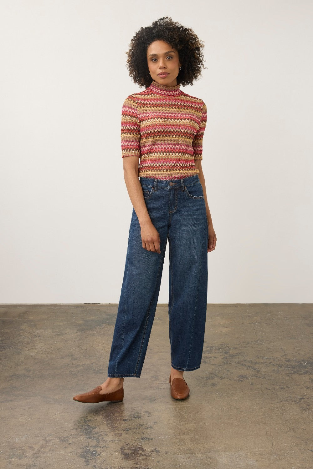 Model wearing Broderick's Clothing Co. FDJ Girlfriend Barrel Ankle dark wash denim jeans with a relaxed fit.