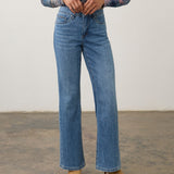 Model wearing Broderick's Clothing Co. FDJ Olivia medium blue denim bootcut jeans with knee panel detail.