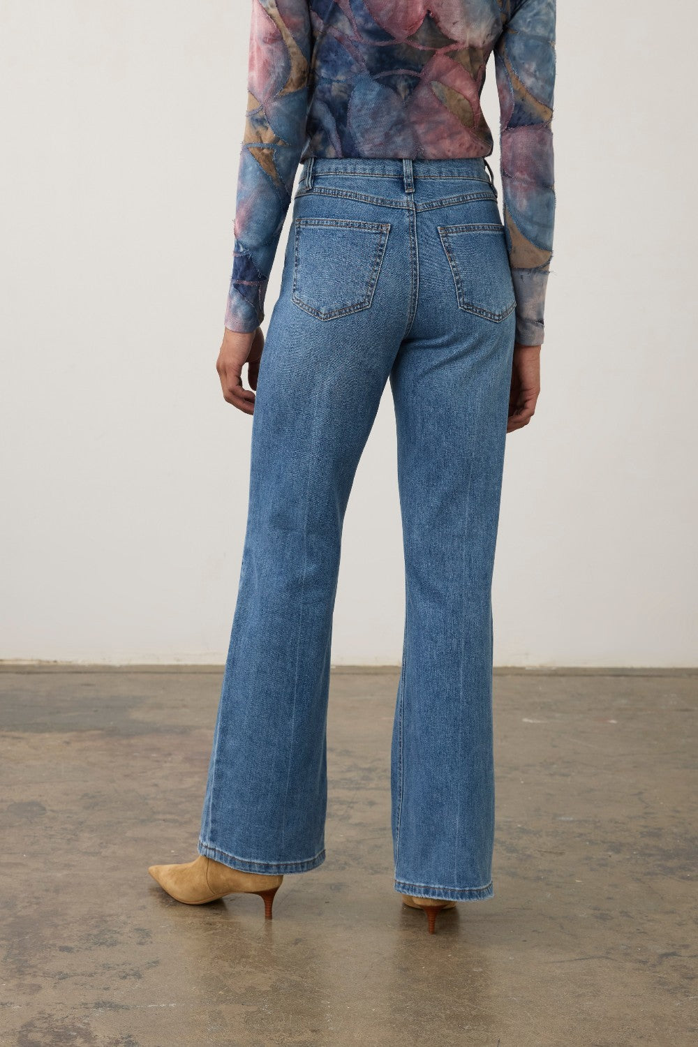 Broderick's Clothing Co. FDJ Olivia medium blue denim bootcut jeans with back panel detail and tan kitten heel boots.
