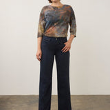 Model wearing Broderick's Clothing Co. FDJ Olivia wide leg navy pants with pintuck detail and a patterned top.