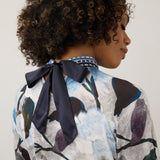 Broderick's Clothing Co. FDJ top featuring a blue and grey floral print with a sophisticated navy bow back neckline.