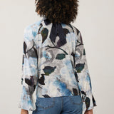 Broderick's Clothing Co. FDJ floral print long sleeve top with a navy blue bow tie back detail worn with blue jeans.