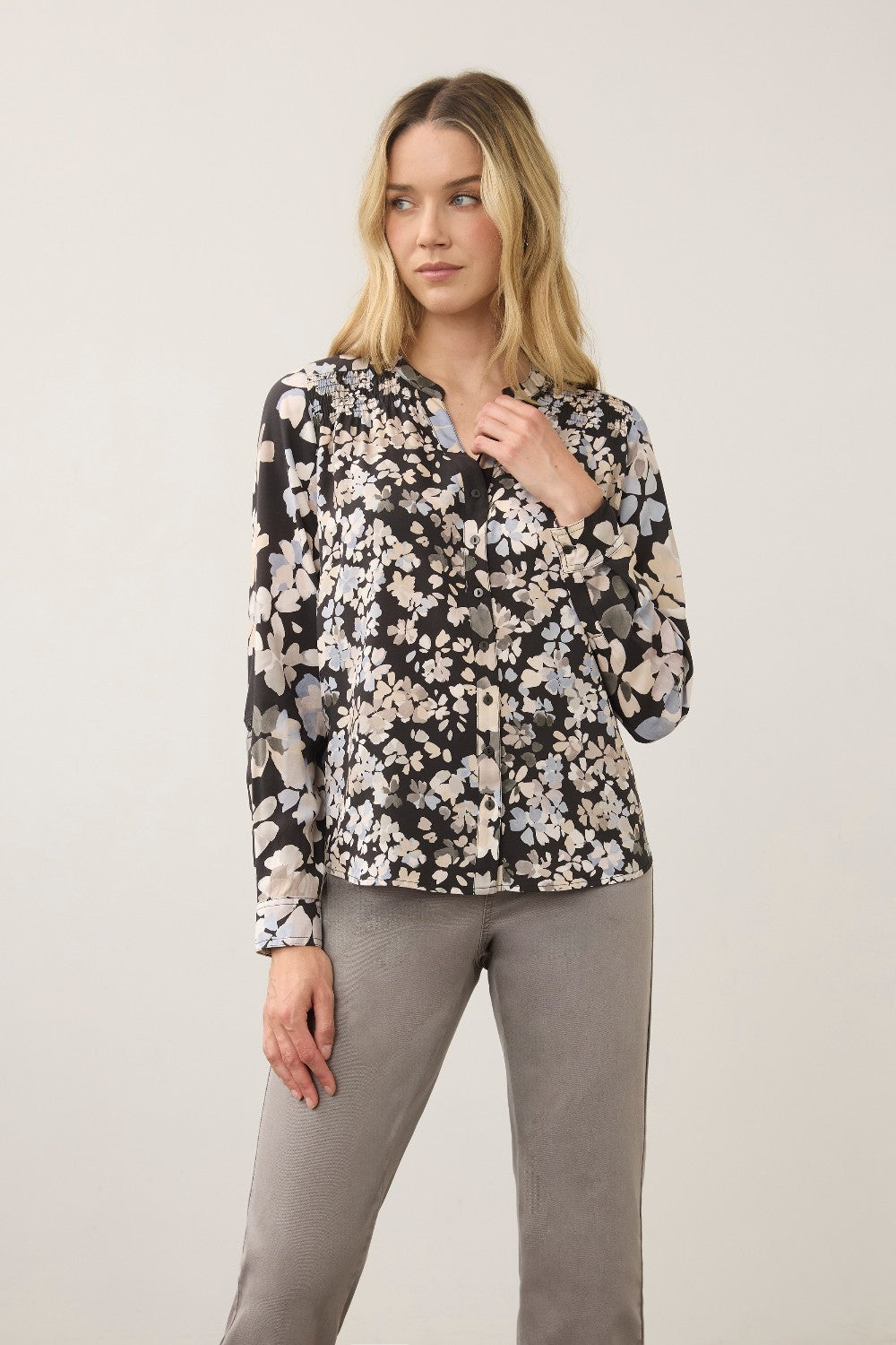 Broderick's Clothing Co. FDJ long sleeve blouse with a black floral print and button-up front on a female model.