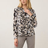 Broderick's Clothing Co. FDJ long sleeve blouse with a black floral print and button-up front on a female model.