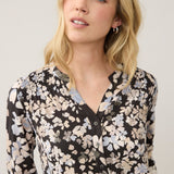 Broderick's Clothing Co. FDJ long sleeve blouse featuring a black floral print with soft blue and beige accents.