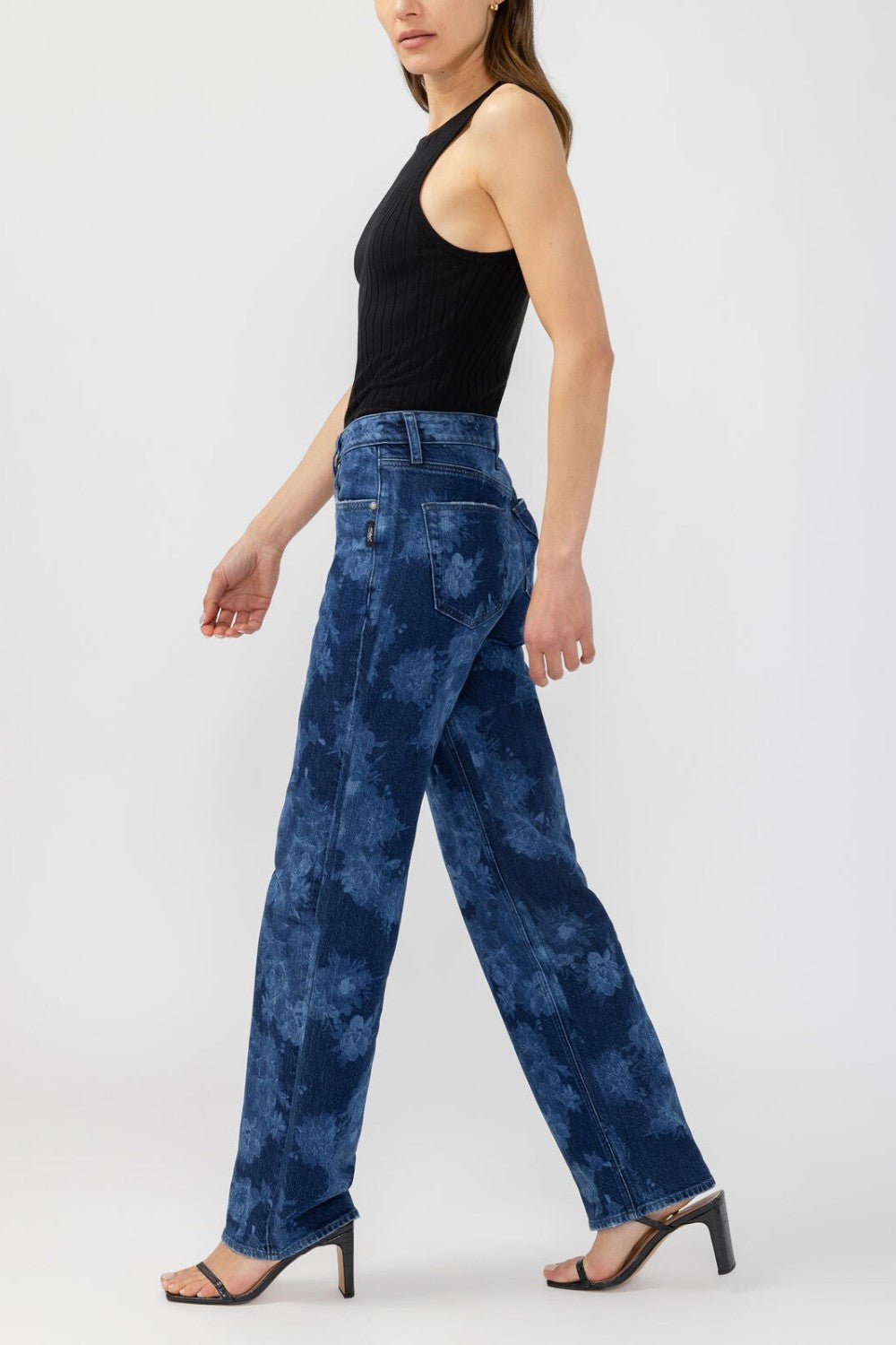 Broderick's Clothing Co. Avery high-rise straight leg jeans with a blue floral print on a model in a black tank top