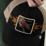 Broderick's Clothing Co. Goorin Bros. black and tan trucker hat featuring a bull patch and yellow lightning bolt detail