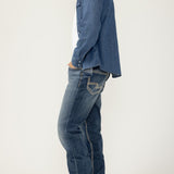Broderick's Clothing Co. Silver Jeans Co. Grayson straight leg jeans in medium wash denim worn by a man side view