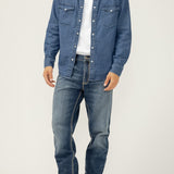 Broderick's Clothing Co. model wearing Silver Jeans Co. Grayson straight leg jeans with a denim shirt and boots