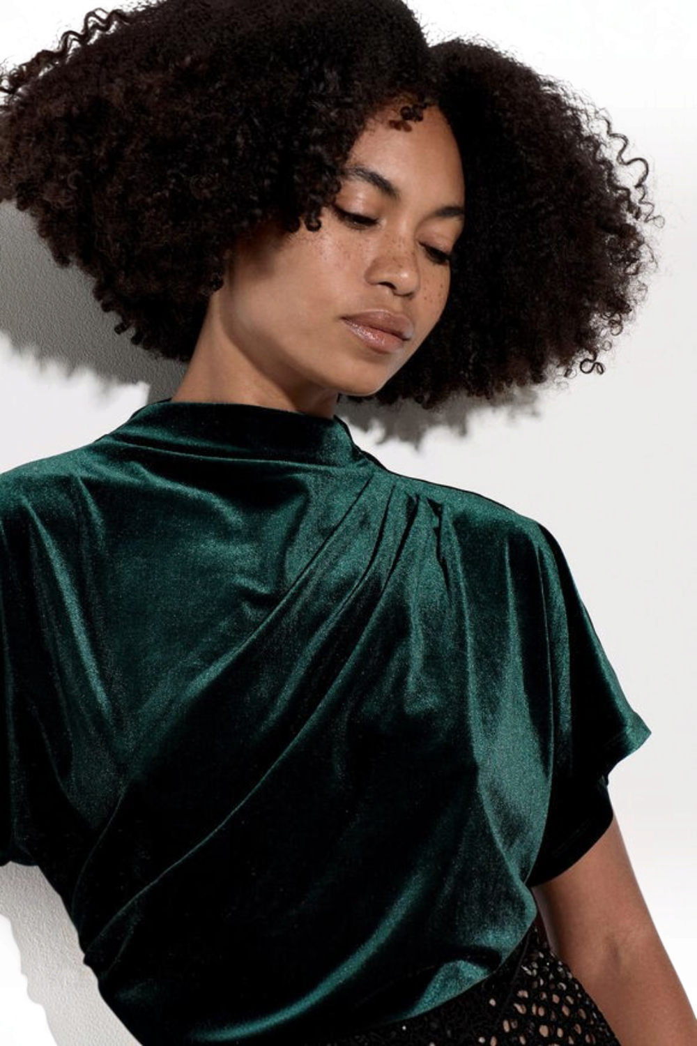 Broderick's Clothing Co. dark green velvet top with a high cowl neck, batwing sleeves, and elegant side ruching.