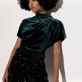 Broderick's Clothing Co. dark green velvet top with a high cowl neck and pleated detail worn by a model.