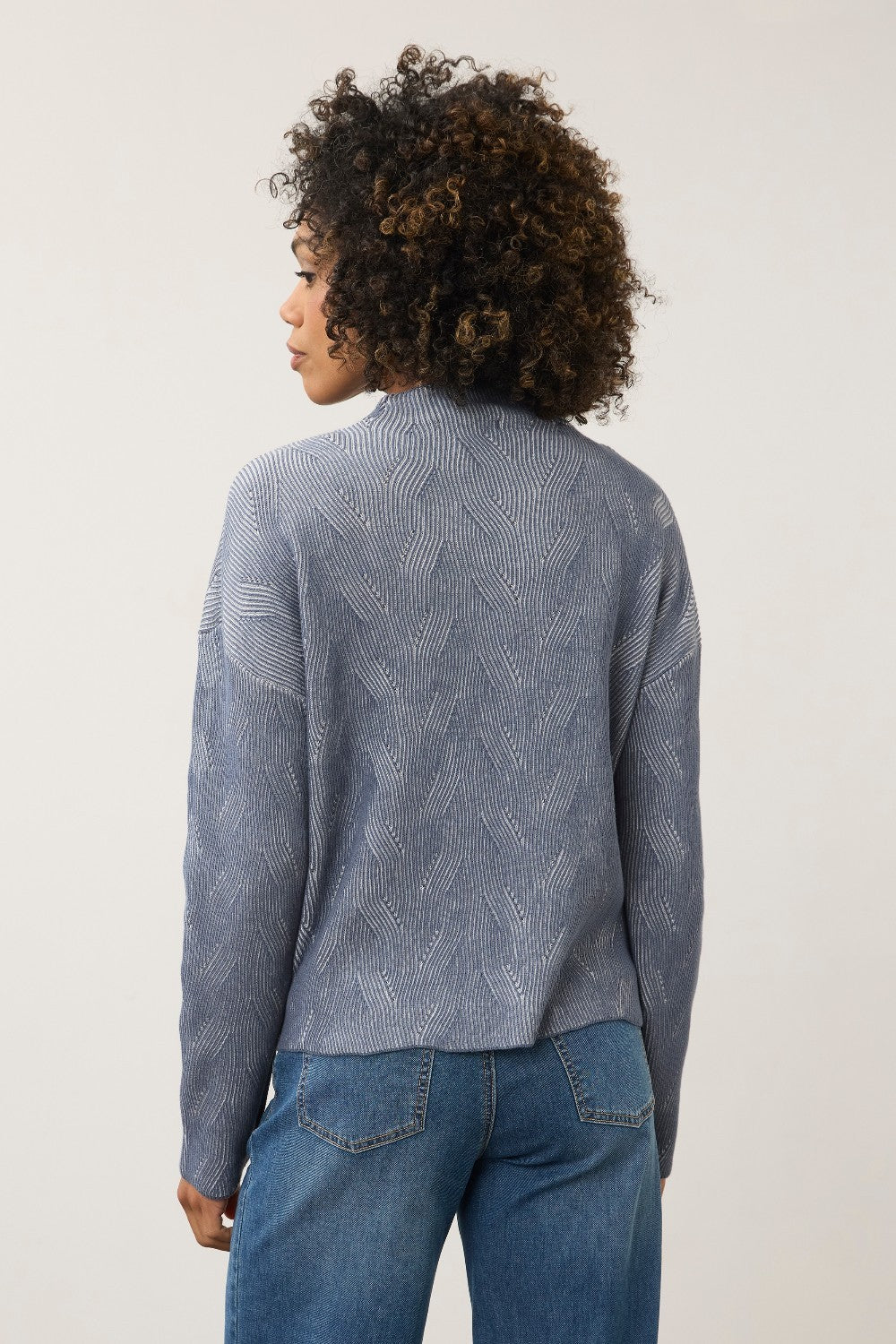 Broderick's Clothing Co. light grey heather funnel neck sweater with textured wave pattern worn by a woman