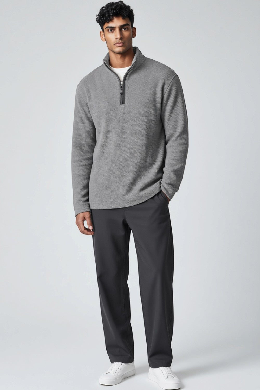 Broderick's Clothing Co. model wearing a grey melange Johnston & Murphy quarter-zip sweater with dark trousers