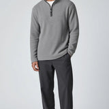 Broderick's Clothing Co. model wearing a grey melange Johnston & Murphy quarter-zip sweater with dark trousers