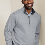 Broderick's Clothing Co. Tommy Bahama grey reversible half-zip sweater worn by a smiling man in a studio setting