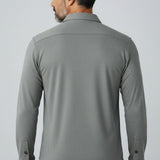Back view of a man wearing a grey Johnnie-O Sequoia Twill Overshirt from Broderick's Clothing Co. over blue jeans.