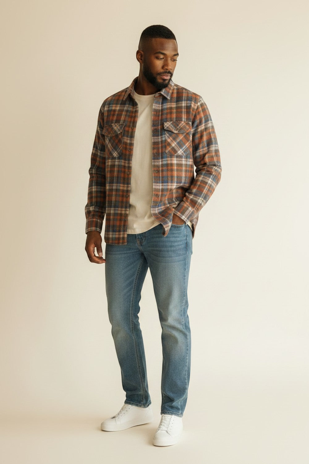 Broderick's Clothing Co. model wearing a Johnston & Murphy heathered plaid woven shirt with jeans and white sneakers.