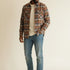 Broderick's Clothing Co. model wearing a Johnston & Murphy heathered plaid woven shirt with jeans and white sneakers.