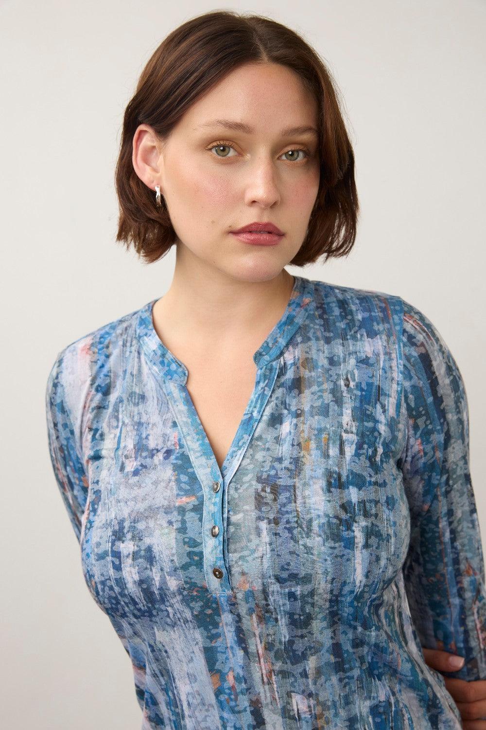 Broderick's Clothing Co. FDJ indigo henley top with three-quarter sleeves and a textured abstract print