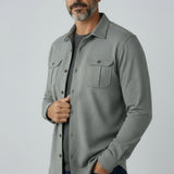 Broderick's Clothing Co. Johnnie-O grey twill overshirt with dual chest pockets worn by a man over a dark t-shirt.